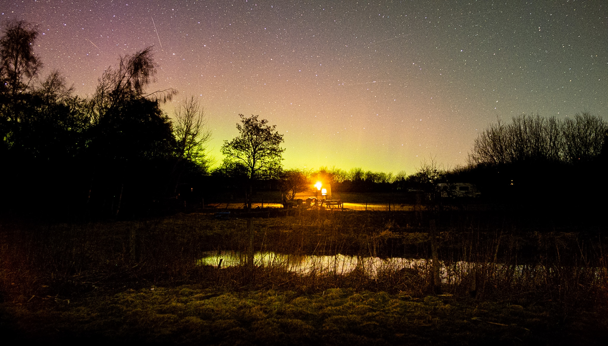 Aurora Borealis and starry sky above Loch Insch touring park at night
